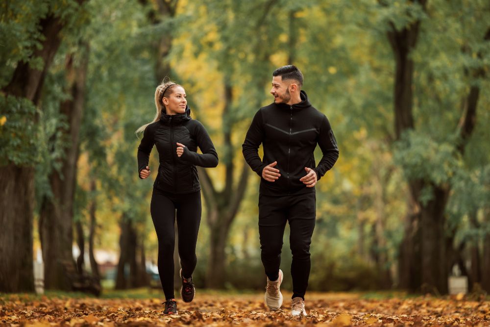 A couple exercising in the fall