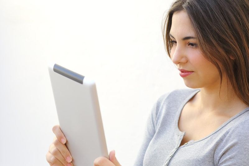 female staring at a tablet