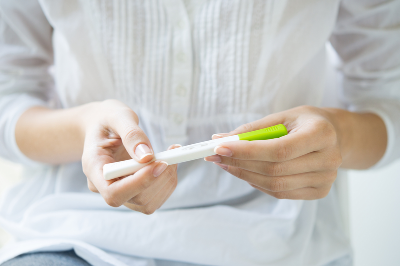 Lady holding a pregnancy test