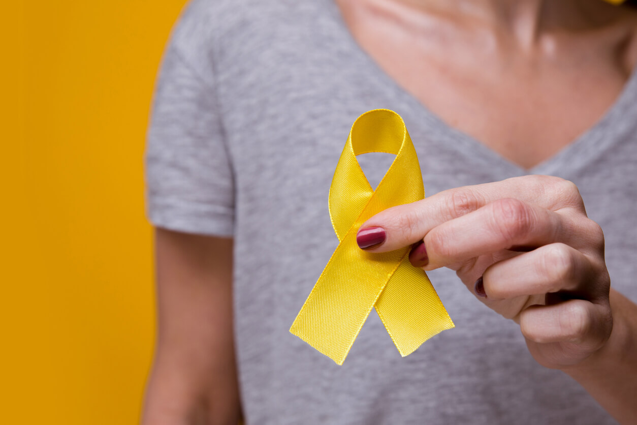 A female holding an endometriosis awareness month ribbon