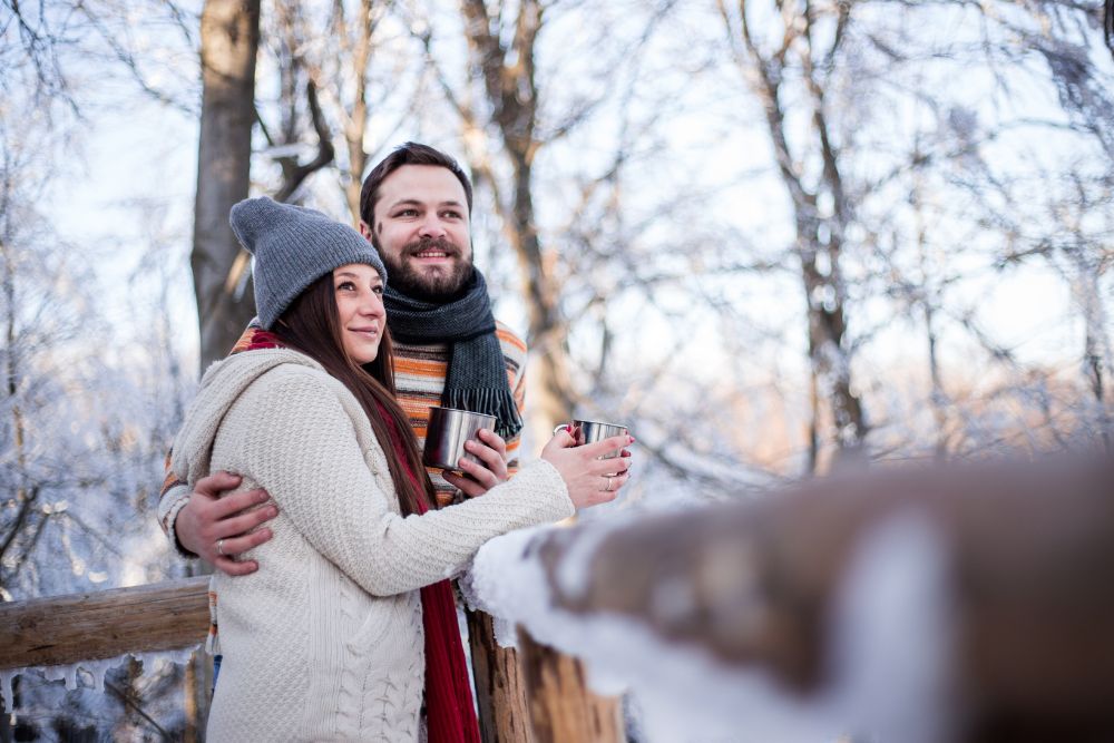 A couple embracing each other on a porch covered in ice