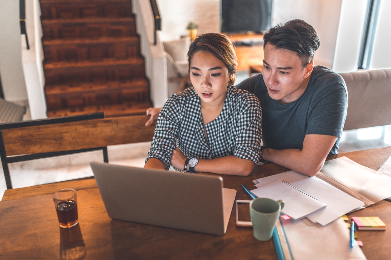 An asian couple researching ovarian stimulation