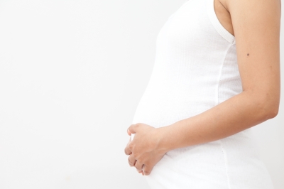 female with her hand on her stomach