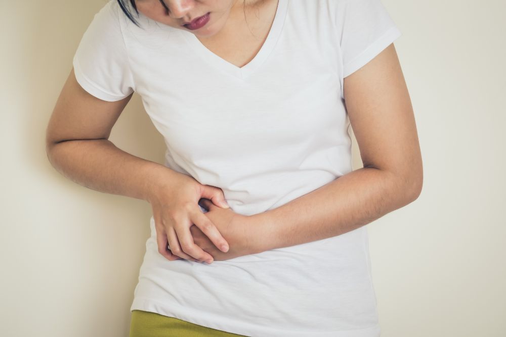 A female experiencing discomfort due to PCOS