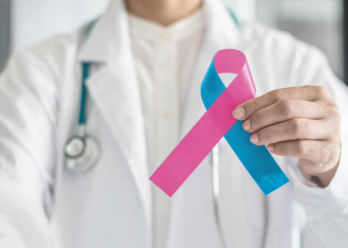 A doctor holding a prematurity awareness ribbon