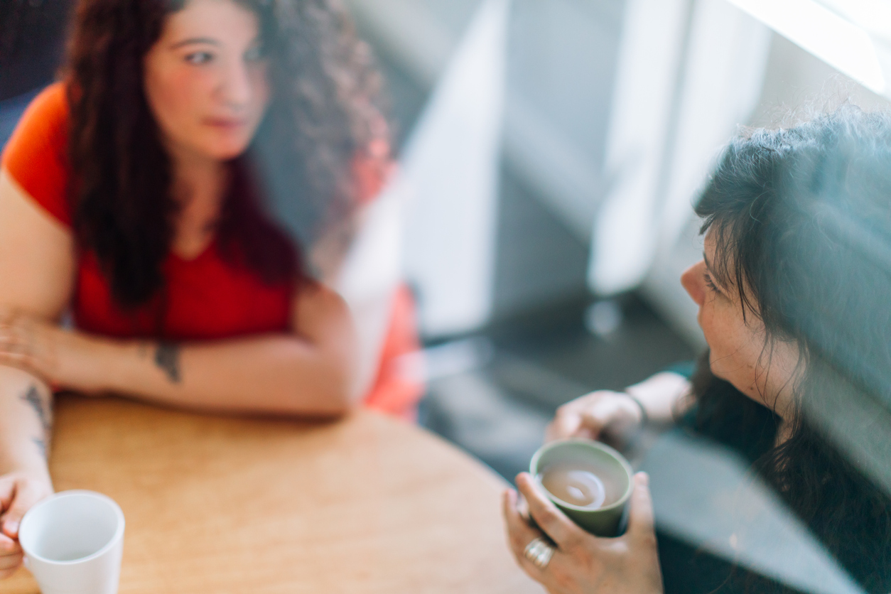 Two females drinking coffee
