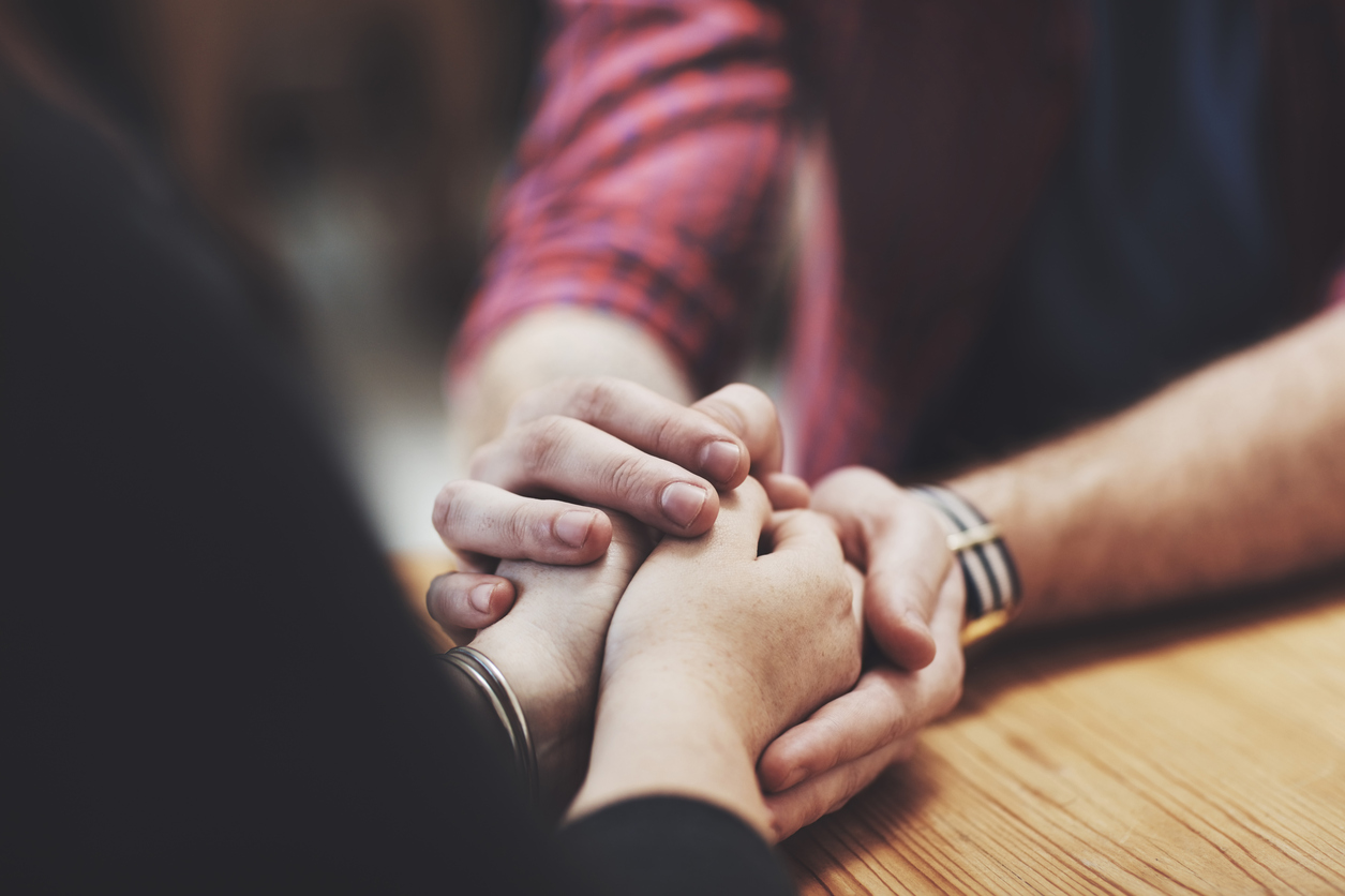 A male holding a females hands
