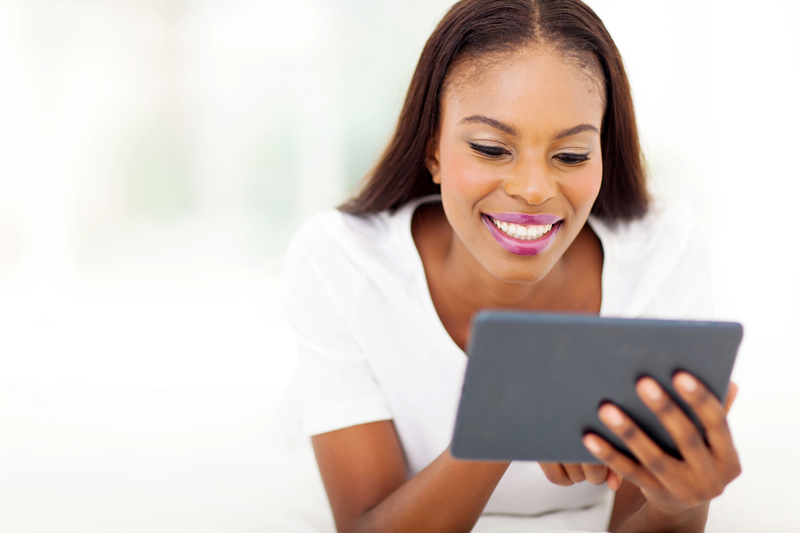 African American female looking at her tablet