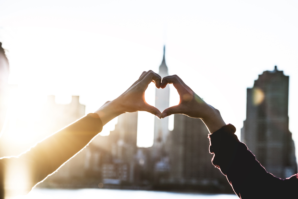 Two people making a heart with their hands