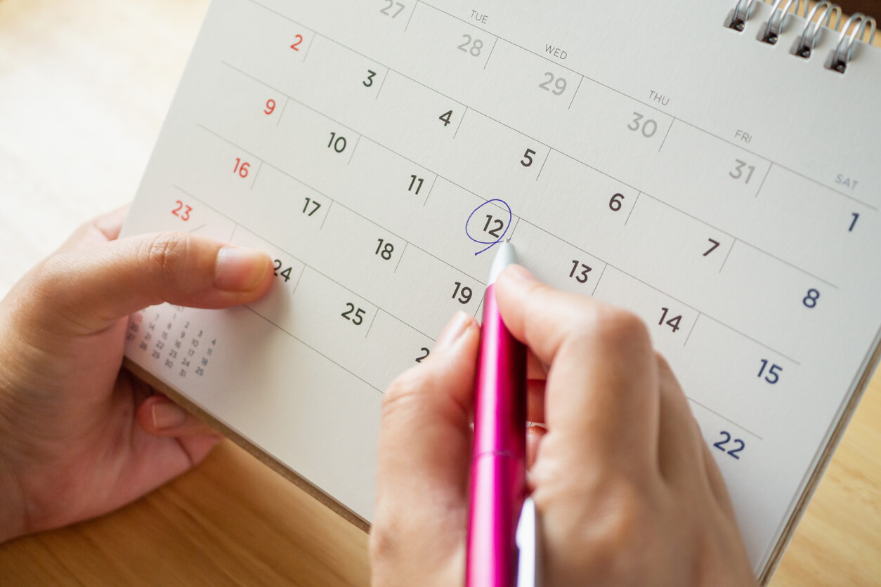 A person marking a calendar