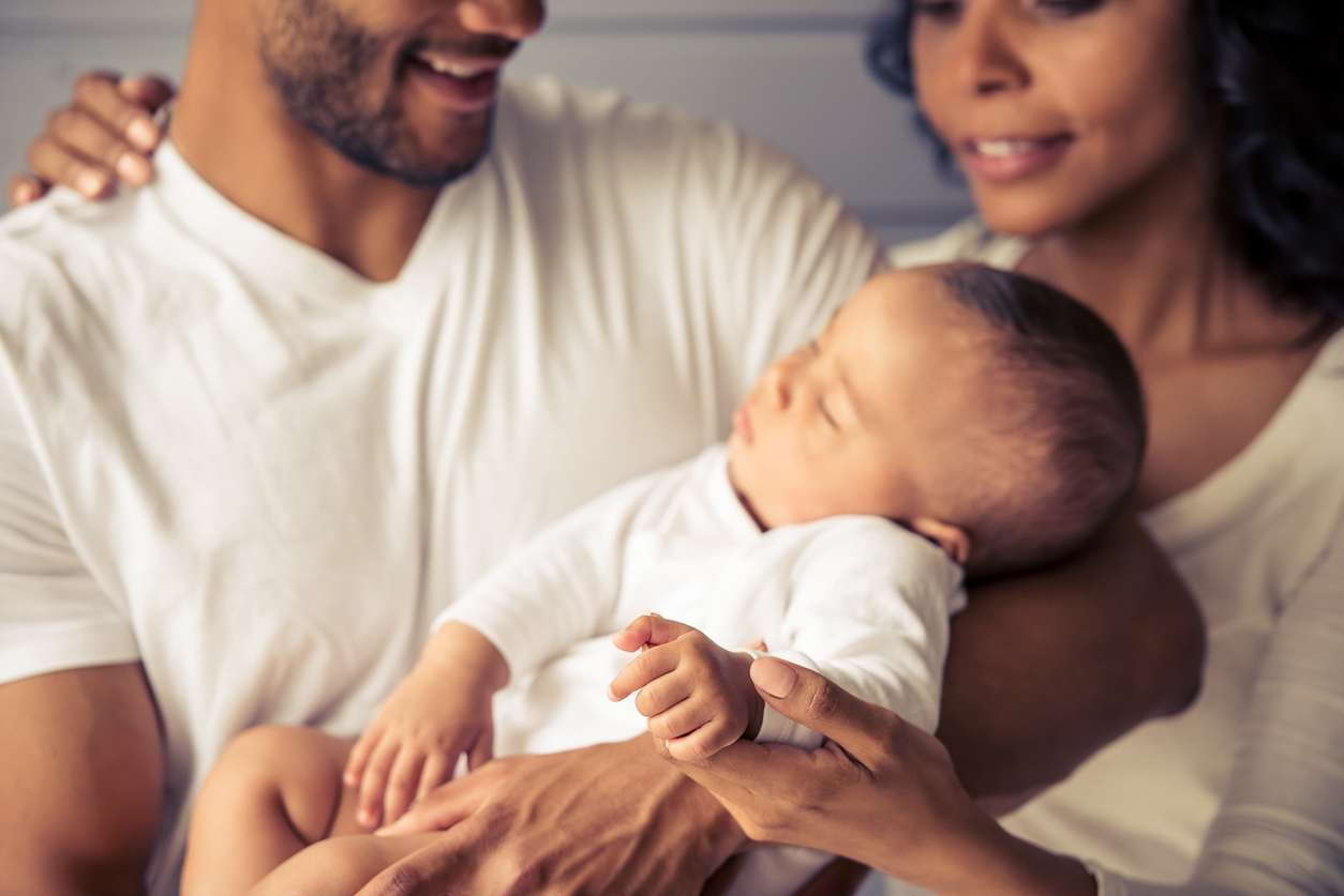 A couple holding a baby