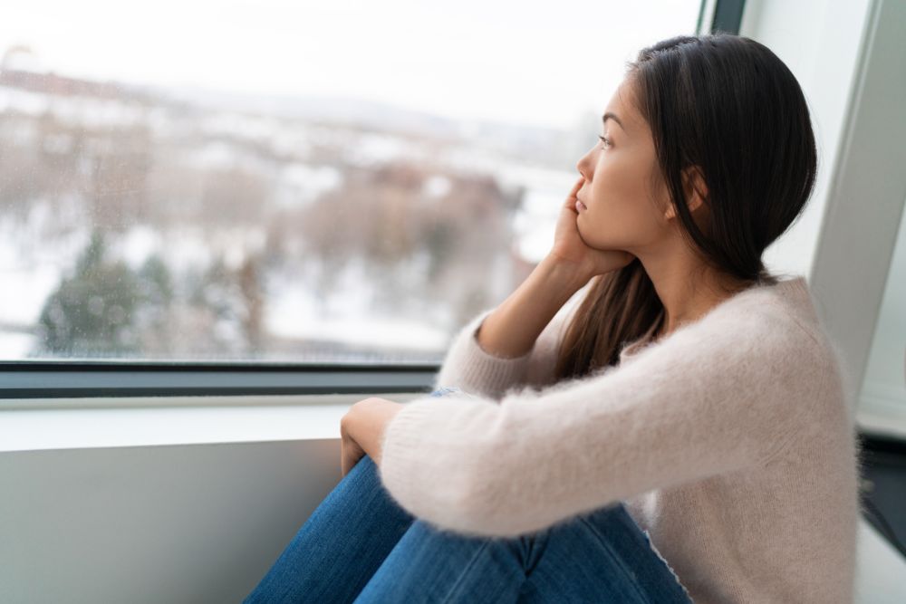 Lady looking outside a window