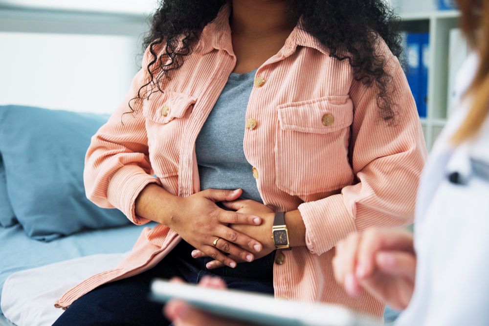 A female explaining symptoms to a fertility specialist