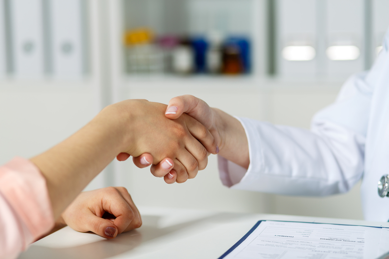 A female patient shakes hands with a fertility doctor