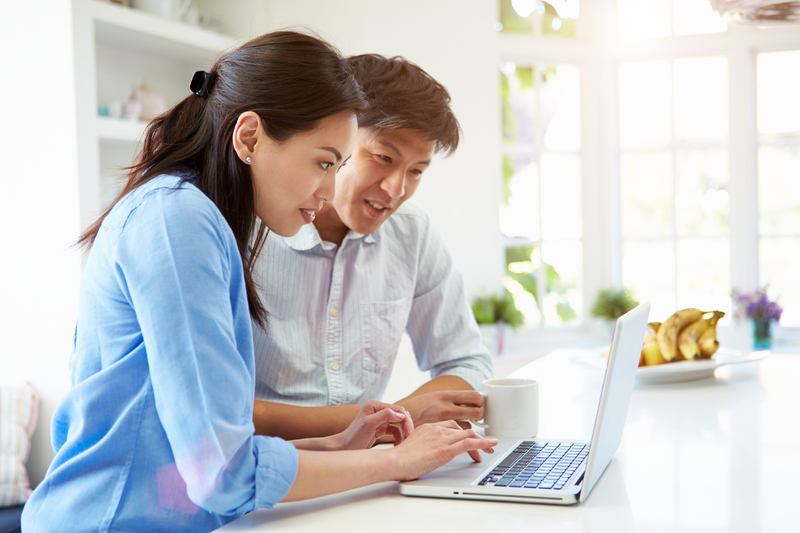 An Asian couple researching egg donation