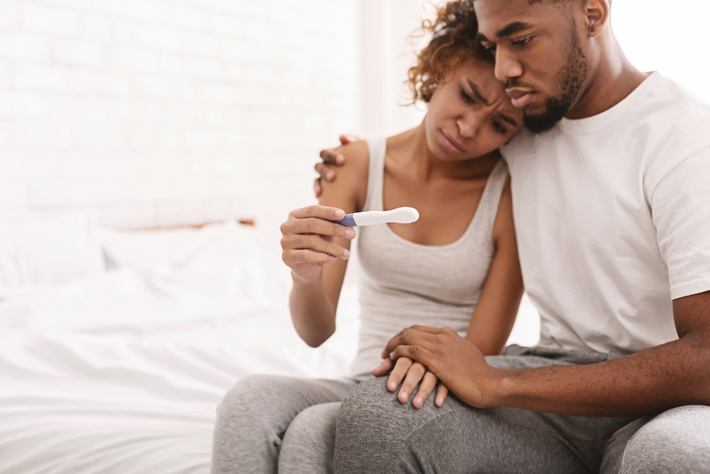 An African American couple disappointed about their pregnancy test