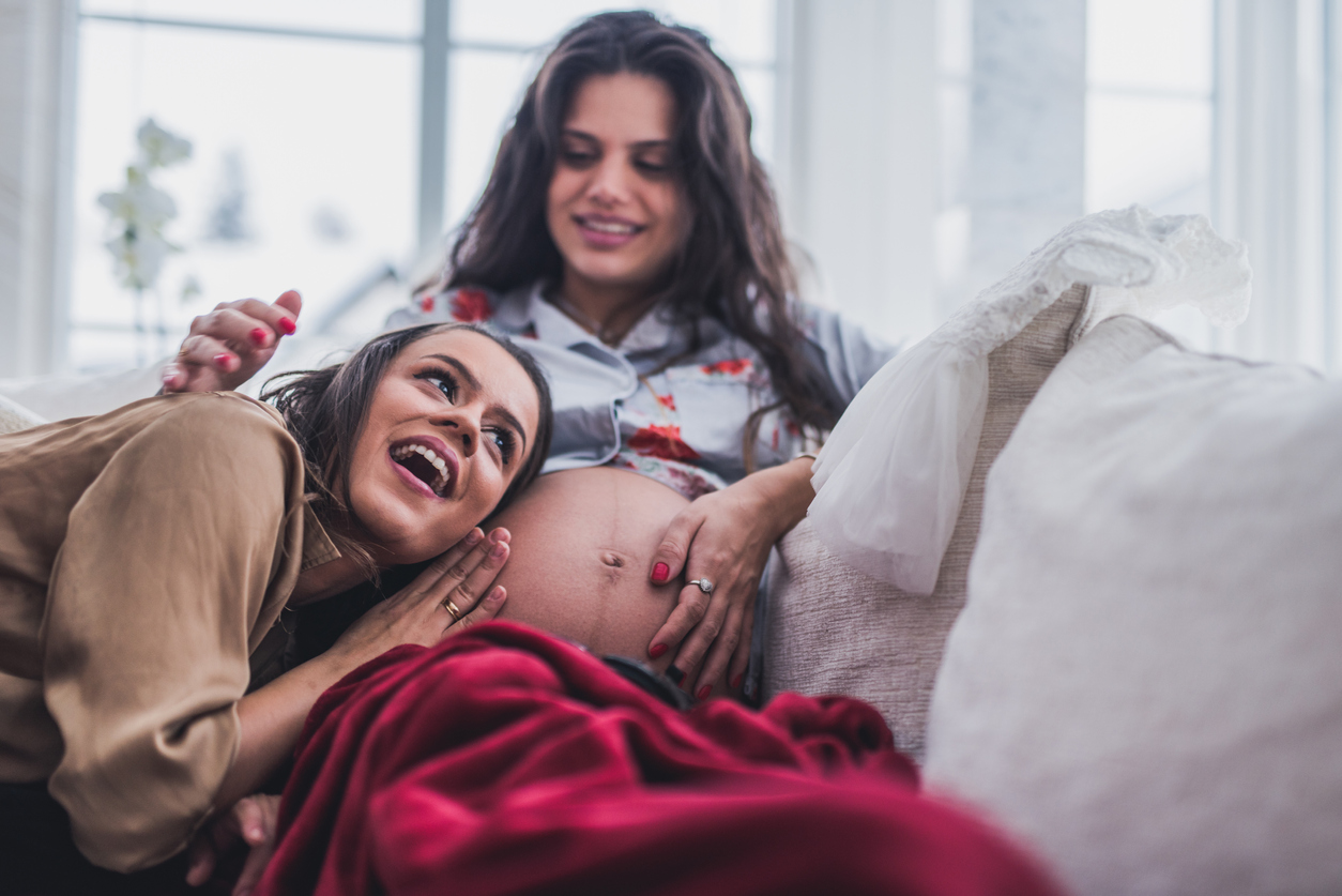 LGBT couple lying on a couch