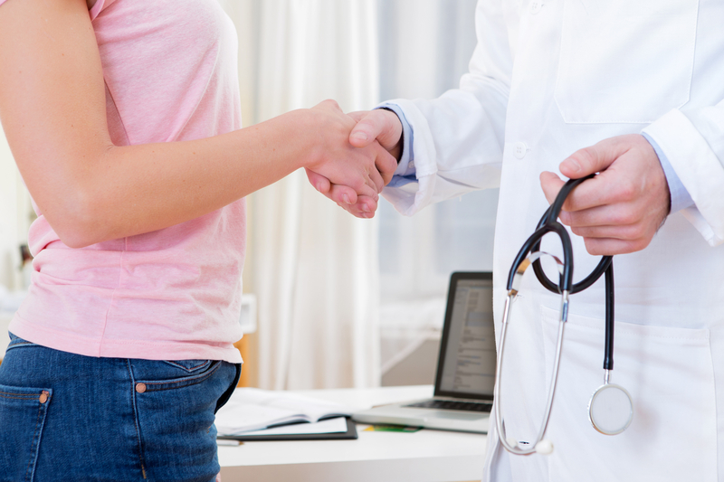 female patient shaking hands with a fertility specialist