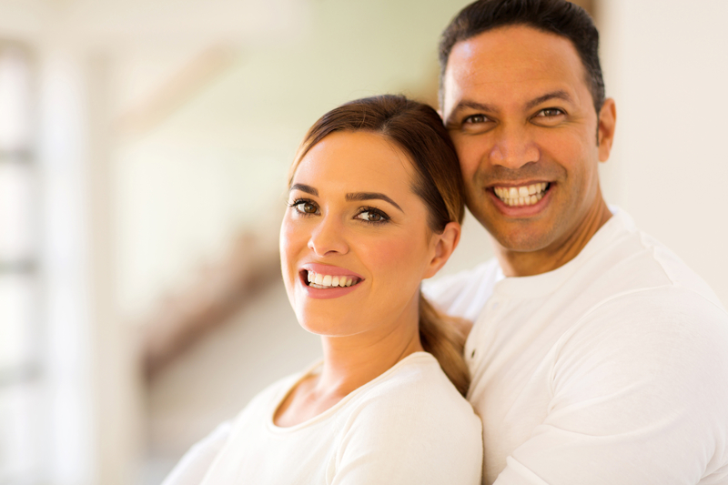 Couple smiling directly at the camera