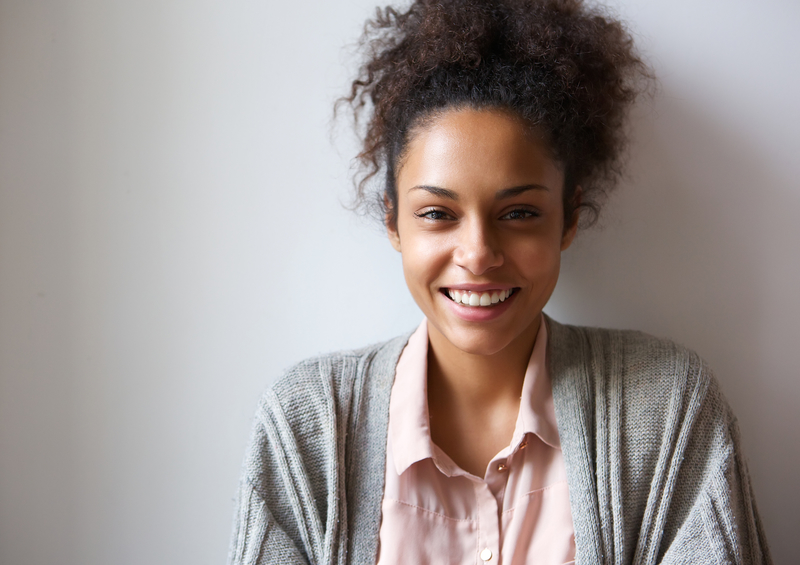 African American smiling while against a white background